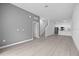 Bright living room featuring neutral colored floors, staircase, and an open kitchen concept at 205 Famagusta Dr, Davenport, FL 33896