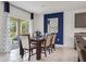 Inviting dining area with stylish lighting, wood table set, and sliding glass doors to outdoor space at 2105 Red Rock Rd, New Smyrna Beach, FL 32168