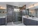 Main bathroom features a gray tile shower with glass enclosure and dual vanities at 2157 Bay Line Rd, Oakland, FL 34787