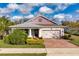 Charming single-story home with brick driveway, manicured lawn, and attached two-car garage at 2157 Bay Line Rd, Oakland, FL 34787