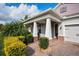 Inviting front porch with brick accents, decorative columns, and well-maintained landscaping at 2157 Bay Line Rd, Oakland, FL 34787