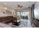 Living room features neutral decor and sliding glass doors leading to the lanai at 2157 Bay Line Rd, Oakland, FL 34787