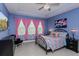 Well-lit main bedroom features a tray ceiling, windows with pink drapes, and a patterned quilt at 2157 Bay Line Rd, Oakland, FL 34787