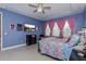 Main bedroom showcasing tray ceiling, and a colorfully appointed bed with large bright windows at 2157 Bay Line Rd, Oakland, FL 34787