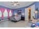 Relaxing main bedroom featuring a tray ceiling, floral bedding and ensuite bathroom access at 2157 Bay Line Rd, Oakland, FL 34787