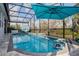 Beautiful in-ground pool with a pool cleaner, umbrella, and an elegant covered lounge chair at 2157 Bay Line Rd, Oakland, FL 34787