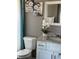 Well-lit bathroom with a modern vanity, granite countertop, and decorative floral accents at 232 Rubino Dr, Davenport, FL 33837