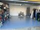 View of a spacious garage with a smooth epoxy floor and ample storage at 232 Rubino Dr, Davenport, FL 33837