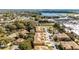 Aerial view of the townhome community with tree coverage and a scenic view of the surrounding area and nearby lake at 2344 Aloha Bay Ct, Ocoee, FL 34761