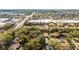 Overhead view of the townhomes nestled amongst trees with commercial areas in the background at 2344 Aloha Bay Ct, Ocoee, FL 34761