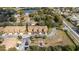 Aerial view of the neighborhood, highlighting the townhomes, landscaping, pond, and nearby amenities at 2344 Aloha Bay Ct, Ocoee, FL 34761