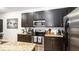 Close-up of a kitchen area featuring granite countertops, stainless steel appliances, and ample cabinetry at 2344 Aloha Bay Ct, Ocoee, FL 34761