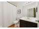 Cozy bathroom features shower with curtain, toilet, and vanity with dark brown cabinets at 2502 Cypress Trace Cir, Orlando, FL 32825