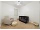 Bright Bedroom with a crib, comfortable chair, and soft carpeting at 2502 Cypress Trace Cir, Orlando, FL 32825