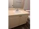 Bathroom vanity with white sink, light colored cabinets, and a chrome faucet at 3028 Parkway Blvd # 305, Kissimmee, FL 34747