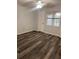 Bedroom featuring wood-look floors, ceiling fan, and a bright window at 3028 Parkway Blvd # 305, Kissimmee, FL 34747