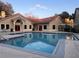 A community pool boasts a beautiful pool house with a red tile roof at 3028 Parkway Blvd # 305, Kissimmee, FL 34747