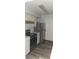 Kitchen featuring black appliances, stainless steel refrigerator, and wood-look flooring at 3028 Parkway Blvd # 305, Kissimmee, FL 34747