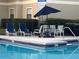 Relax poolside with ample seating and shade from an umbrella at 3028 Parkway Blvd # 305, Kissimmee, FL 34747