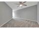 Spacious bedroom with grey carpet, a ceiling fan, and neutral colored walls at 3086 Fieldwood Cir, St Cloud, FL 34772