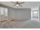 Large empty bedroom with grey carpet and neutral walls with a ceiling fan and a closet at 3086 Fieldwood Cir, St Cloud, FL 34772