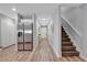 Hallway with stainless steel refrigerator, staircase, and neutral decor at 3086 Fieldwood Cir, St Cloud, FL 34772