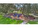 Community playground surrounded by mature trees offering a fun, shaded area at 3086 Fieldwood Cir, St Cloud, FL 34772