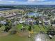 Panoramic aerial view capturing homes, a serene lake, and the picturesque surrounding community at 331 Bay St, Auburndale, FL 33823