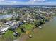 Beautiful aerial view showcasing lakefront homes with docks and lush green landscaping within the community at 331 Bay St, Auburndale, FL 33823