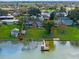 Waterfront homes featuring a private dock, lush lawns, and tranquil lake views in a charming neighborhood at 331 Bay St, Auburndale, FL 33823