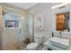 Bathroom featuring a glass-enclosed shower, vessel sink, and sliding barn door-style mirror at 331 Bay St, Auburndale, FL 33823