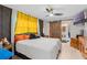 Bedroom with a sliding barn door, ceiling fan, and TV at 331 Bay St, Auburndale, FL 33823