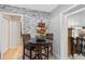 Breakfast nook with wooden table, chairs, and stone accent wall at 331 Bay St, Auburndale, FL 33823