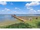 Private dock with a charming gazebo overlooking the calm lake and blue skies at 331 Bay St, Auburndale, FL 33823