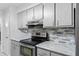 Modern kitchen featuring gray cabinets, marble countertops, and stainless steel appliances at 331 Bay St, Auburndale, FL 33823