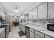 Modern kitchen featuring gray cabinets, marble countertops, and stainless steel appliances at 331 Bay St, Auburndale, FL 33823