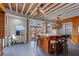 Living room featuring a bar area, outdoor view, and a white-washed ceiling at 331 Bay St, Auburndale, FL 33823