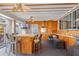 Spacious living room with white-washed ceiling, a tv, and a bar area at 331 Bay St, Auburndale, FL 33823