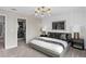 Bedroom featuring neutral tones, a walk-in closet, and modern lighting for a relaxing ambiance at 3348 Vine Leaf St, Apopka, FL 32712