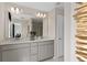 Bathroom featuring double sinks, modern vanity, and a large mirror at 3372 Vine Leaf St, Apopka, FL 32712