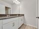 This bathroom features a large mirror, double granite vanity, and tile flooring at 3431 Islewood Ct, Ocoee, FL 34761