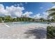 Resort-style community pool with palm trees, clear blue sky, and ample seating at 3431 Islewood Ct, Ocoee, FL 34761