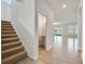 Staircase leading to a hallway and half bath with tile and carpet flooring at 3431 Islewood Ct, Ocoee, FL 34761