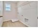 A tiled laundry room featuring a window, a wire shelf, and hookups for appliances at 3431 Islewood Ct, Ocoee, FL 34761