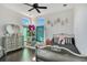 Bedroom featuring a silver-painted bed frame, large dresser and accents of black and pink at 34500 Tree Frog Ln, Eustis, FL 32736