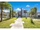 Modern two-story home featuring a manicured lawn and distinctive walkway at 34500 Tree Frog Ln, Eustis, FL 32736