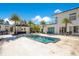 Modern pool with a separate spa and cabana with an outdoor kitchen and palm trees at 34500 Tree Frog Ln, Eustis, FL 32736