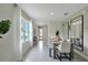 Bright dining area with a view to the front entrance, stylish decor and modern furniture at 3476 Sandalwood Isle Way, Ocoee, FL 34761