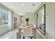 Dining area is well lit and features a stylish dining set with sleek mirrors on the back wall at 3476 Sandalwood Isle Way, Ocoee, FL 34761