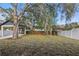 The backyard features a carport and is surrounded by fencing at 355 Anderson Dr, Groveland, FL 34736